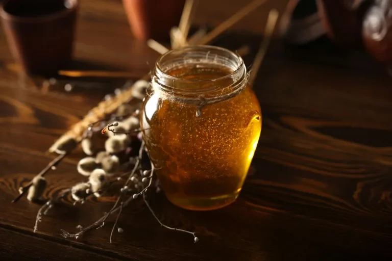 Jar of raw honey on a wooden table as a natural alternative to artificial sweeteners