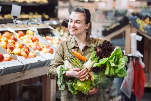 Woman shopping for fresh vegetables and whole foods at a grocery store