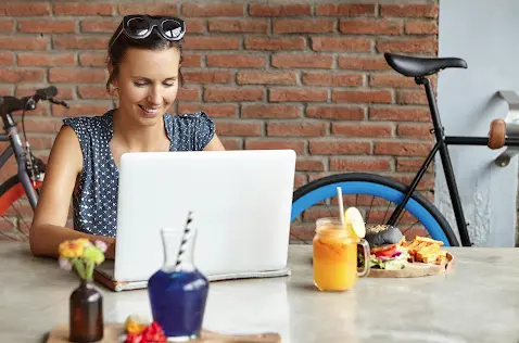 Girl using her computer while lunch