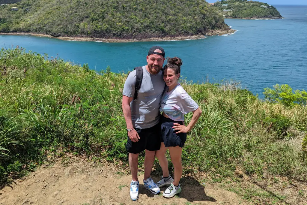 Christina Speranza enjoying outdoor adventures and travel with her partner along a coastal landscape