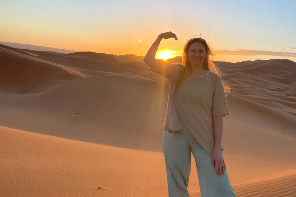 Rebecca Haywood enjoying a sunset in the desert during her travels.