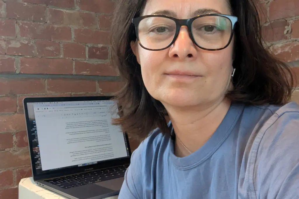 Viosa Koronica Barileva working on nutrition and wellness content from a home office workspace.