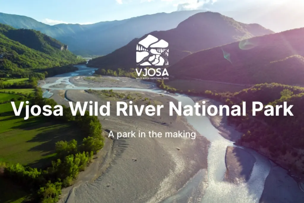 Aerial view of Vjosa Wild River National Park, Europe’s first wild river national park, winding through a mountainous landscape.