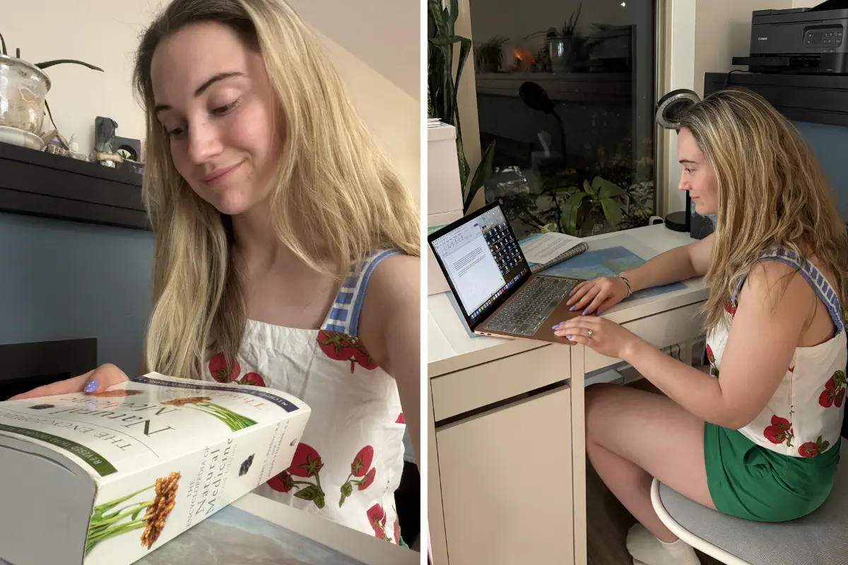 Breleigh Loader reading a nutrition textbook and studying on her laptop as part of her Institute of Holistic Nutrition education.